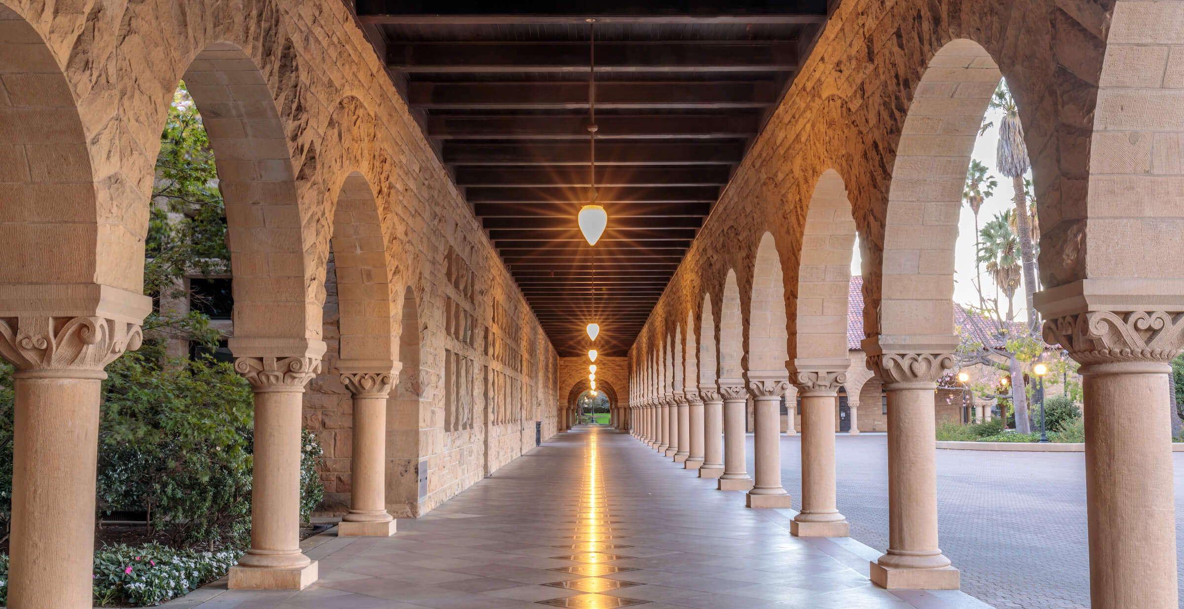 Outdoor archway with lights hanging in a row