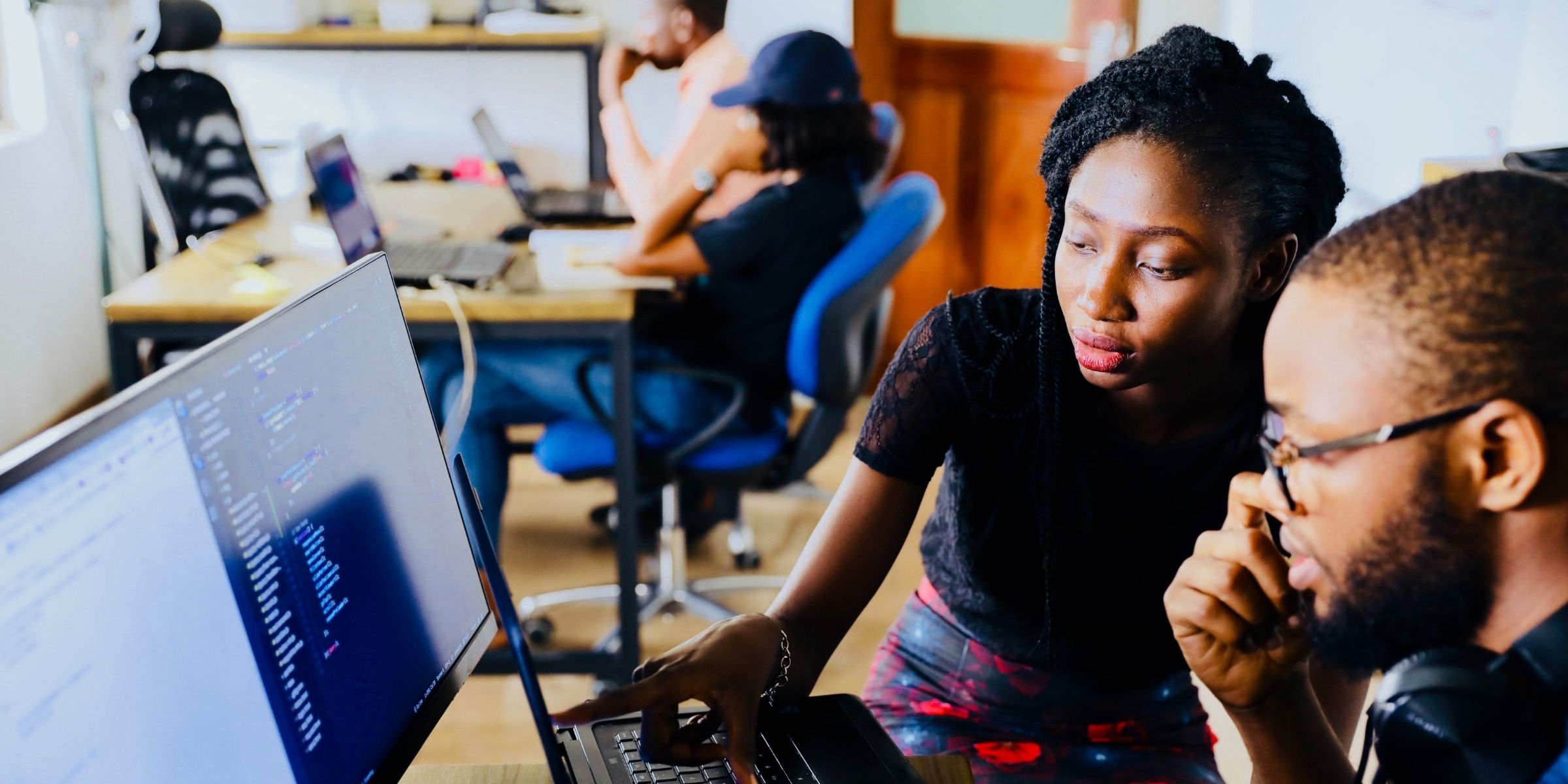 two students looking at a computer screen
