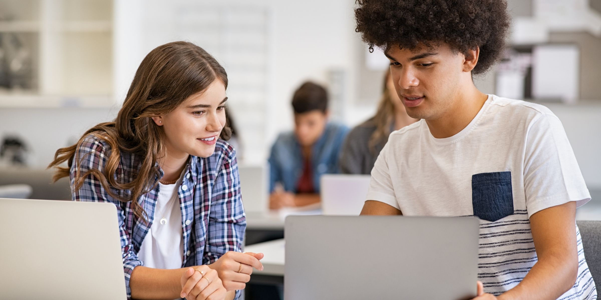 two students looking at laptop