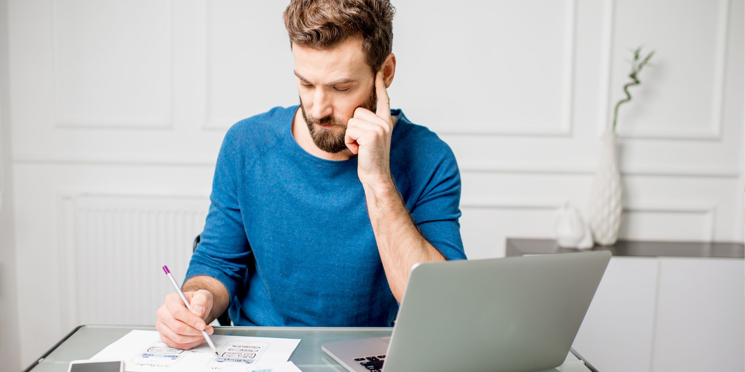 A professional looking at a piece of paper and thinking